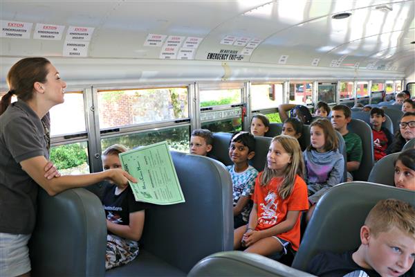 Students talk about safe bus behavior. 